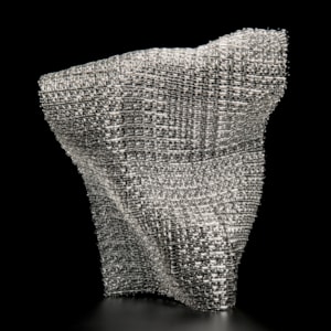 layered fused glass sculpture resembling fabric mesh