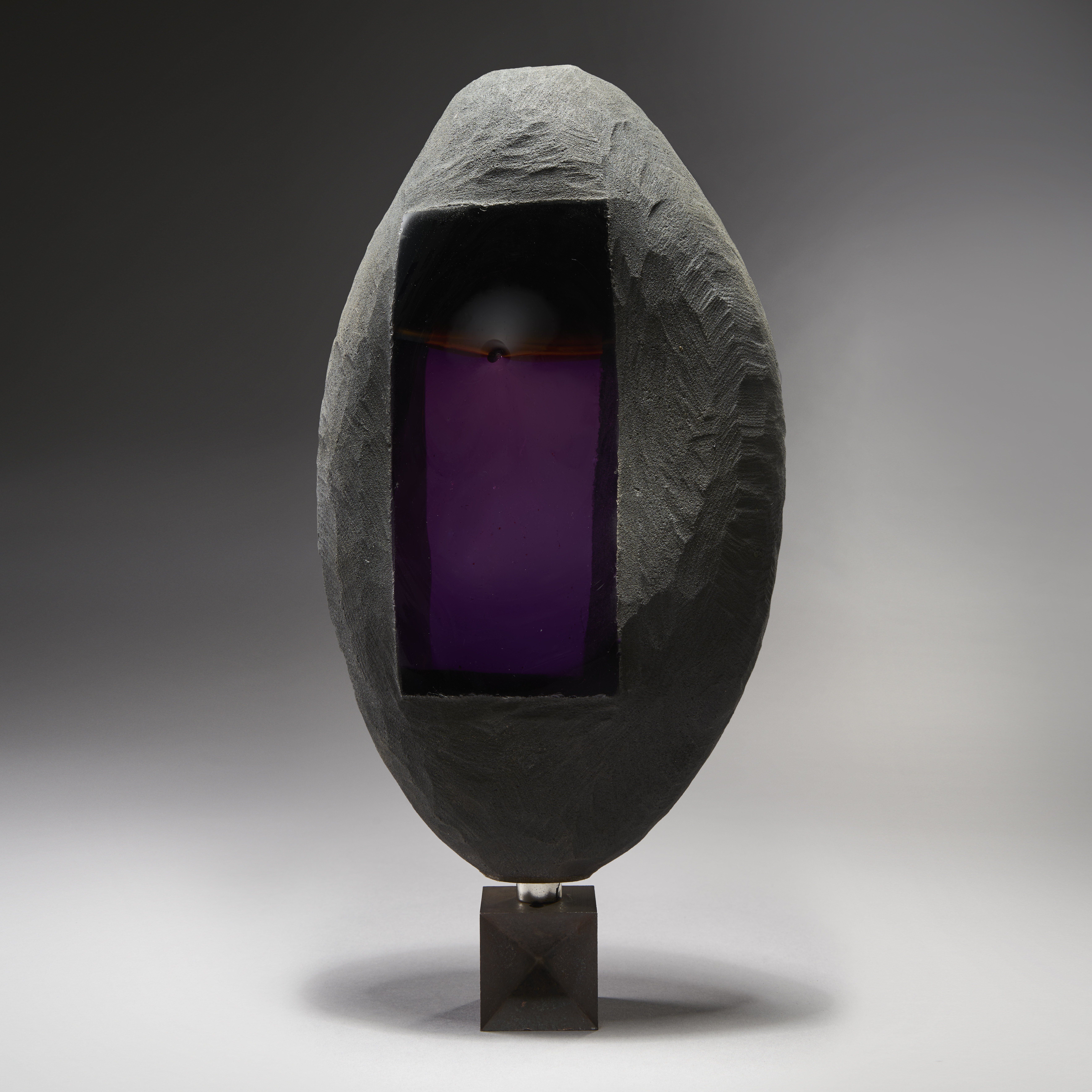 modern oval shaped art glass and metal sculpture in grey with rectangular purple centre