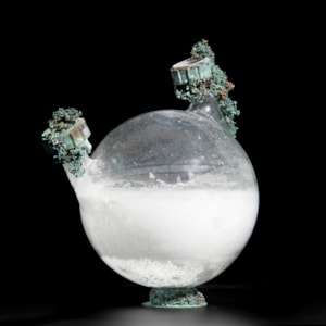 art-glass globe sculpture of water container with metal adornments