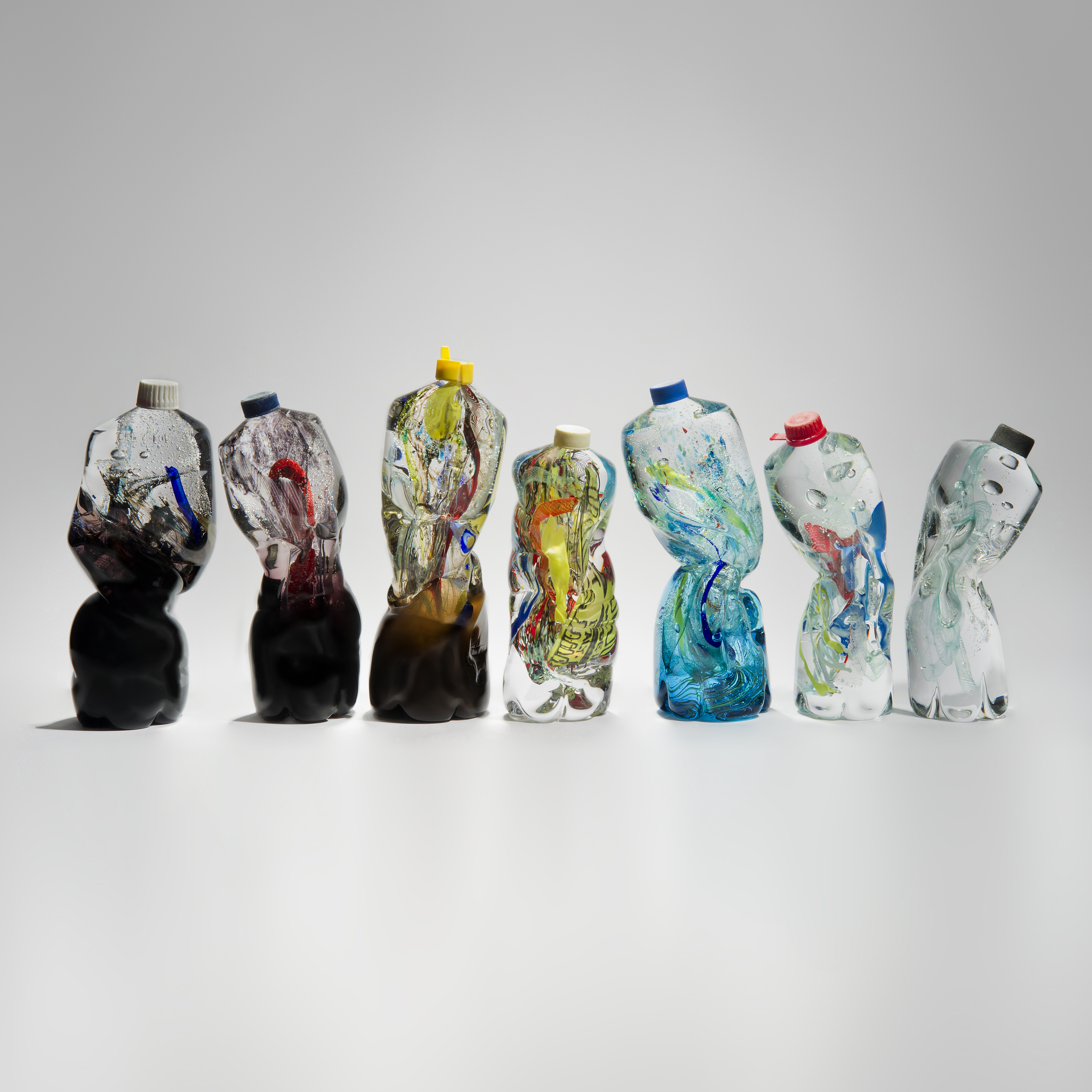 art-glass sculpture of crumpled wasted plastic bottles 