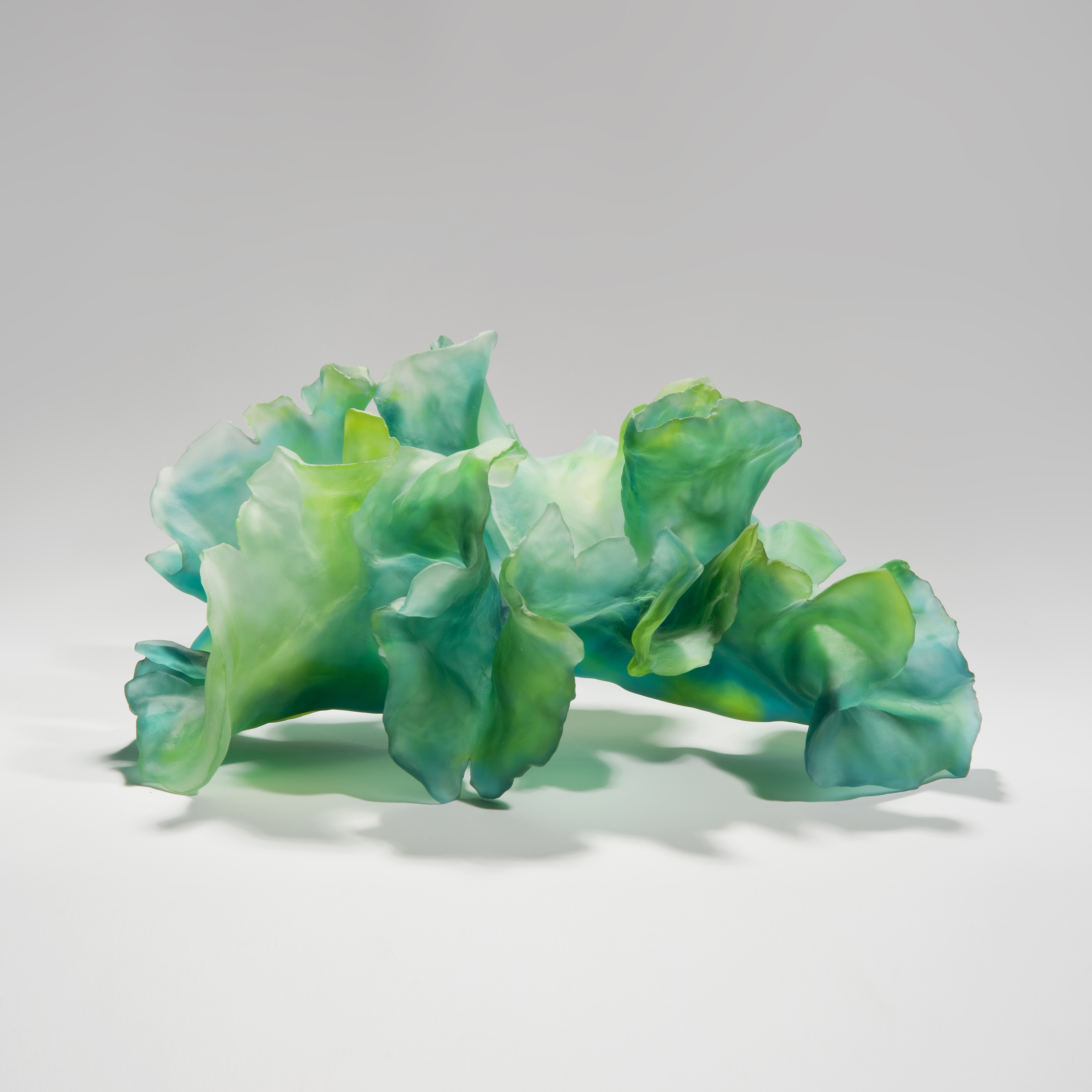 contemporary art-glass sculpture of leaves in bright green