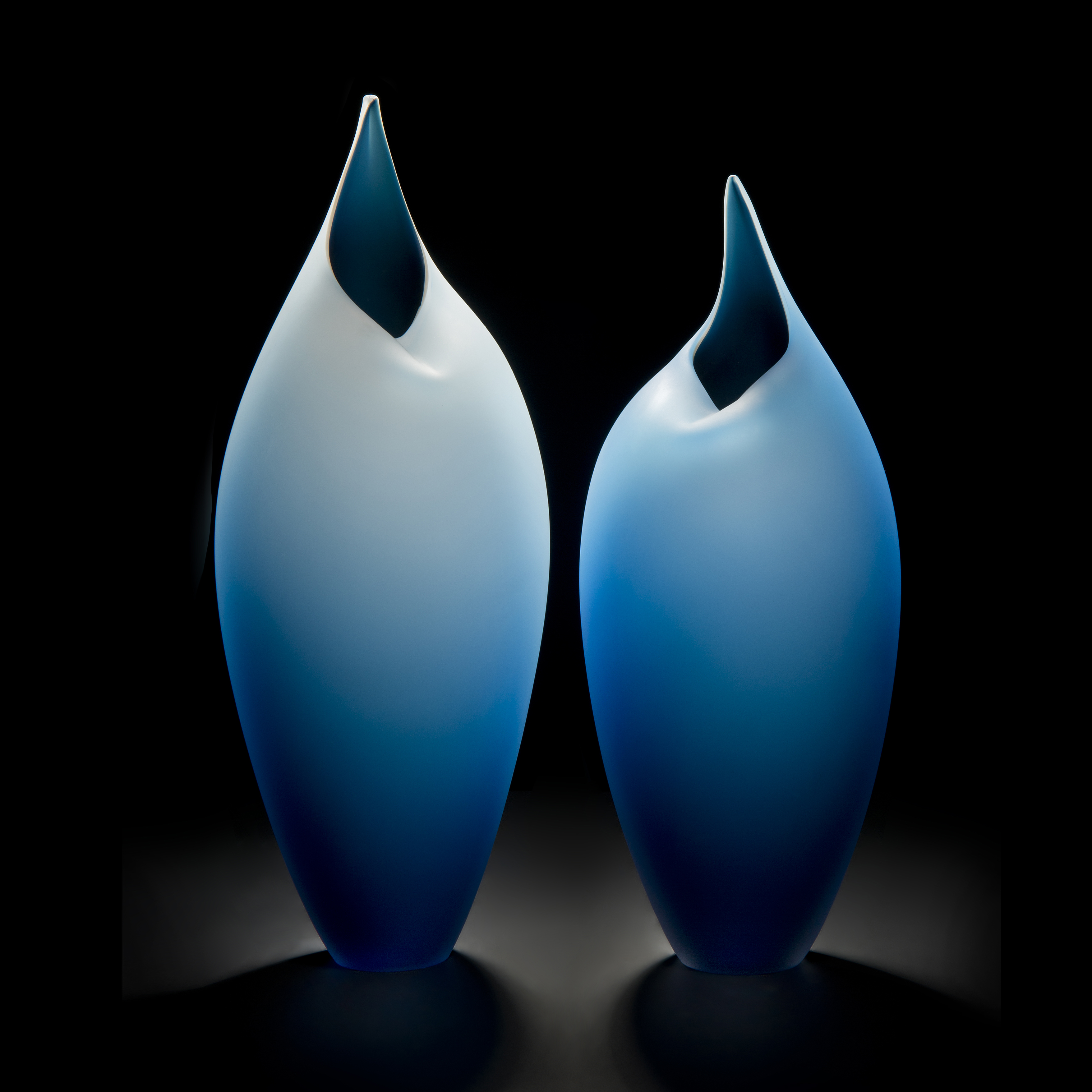 minimal blown glass sculpture of two birds in blue