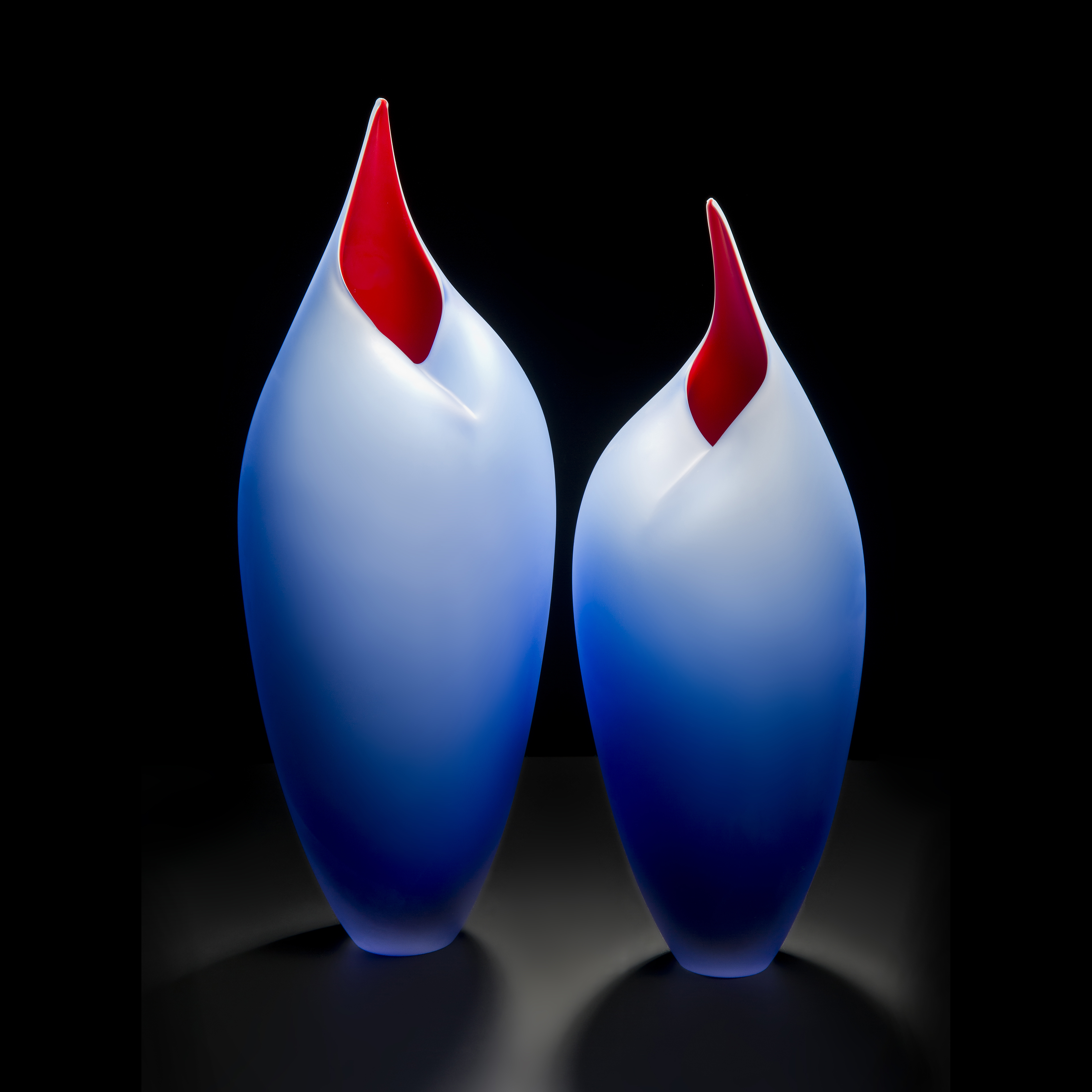 minimalist blown glass sculpture of birds in blue and red