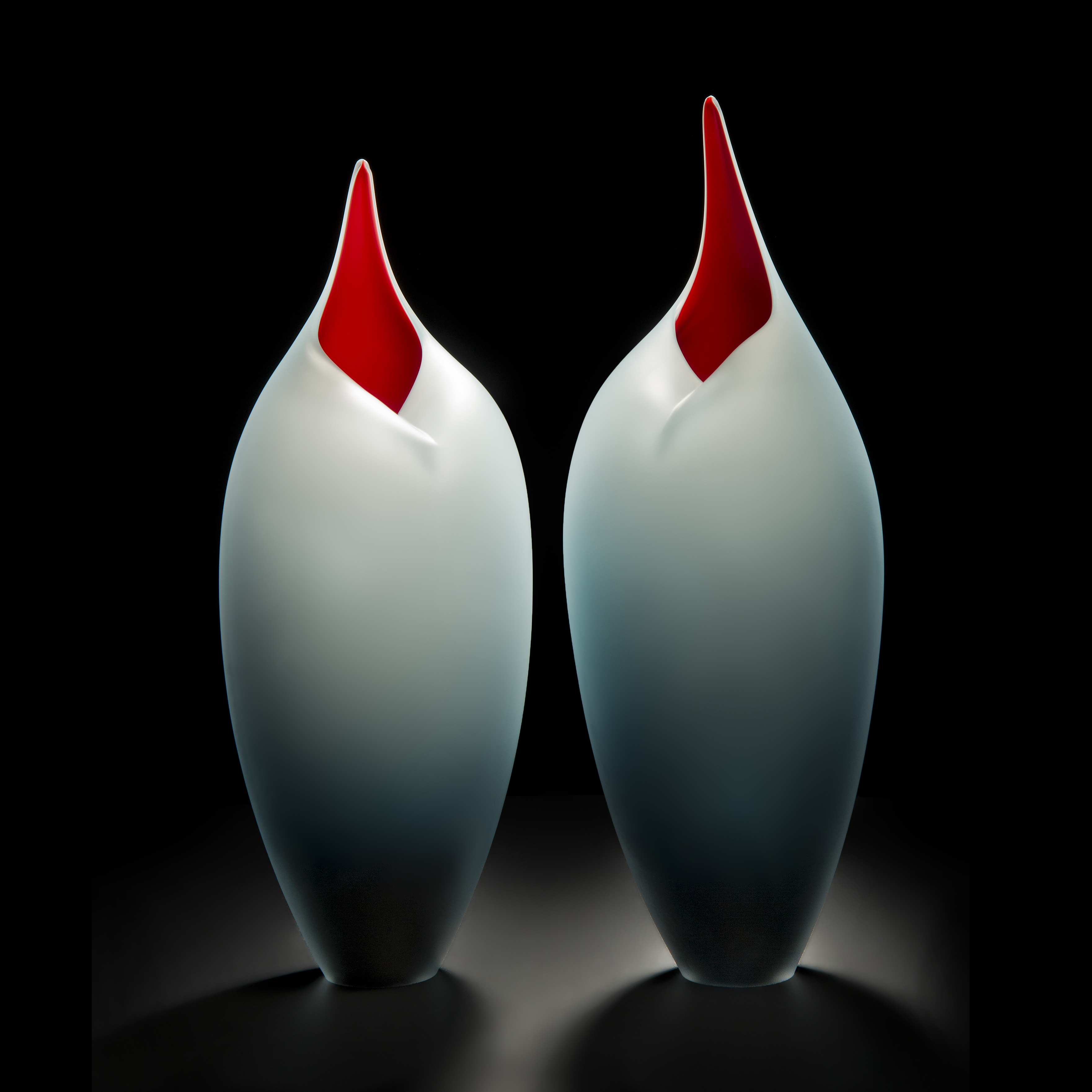 minimal blown glass sculpture of birds in red and steel