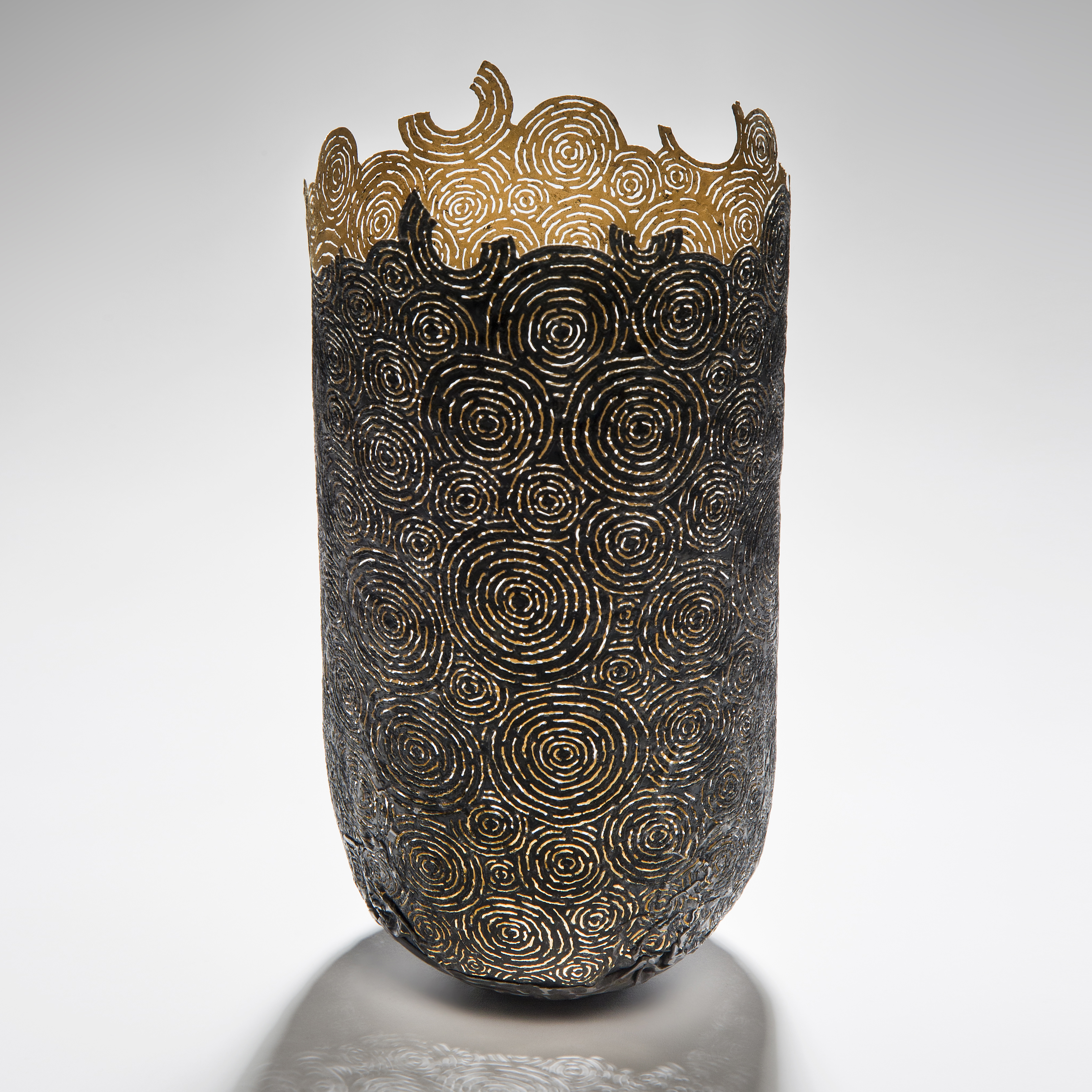 tall open top sculpted vessel made from circular cut pieces of metal and wood