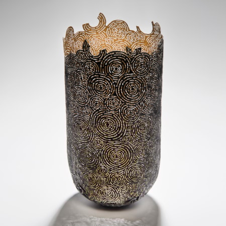 tall open top sculpted vessel made from circular cut pieces of metal and wood