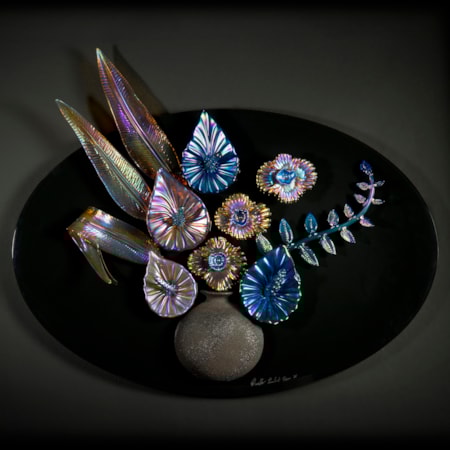 oil coloured art glass sculpture of flowers and vase