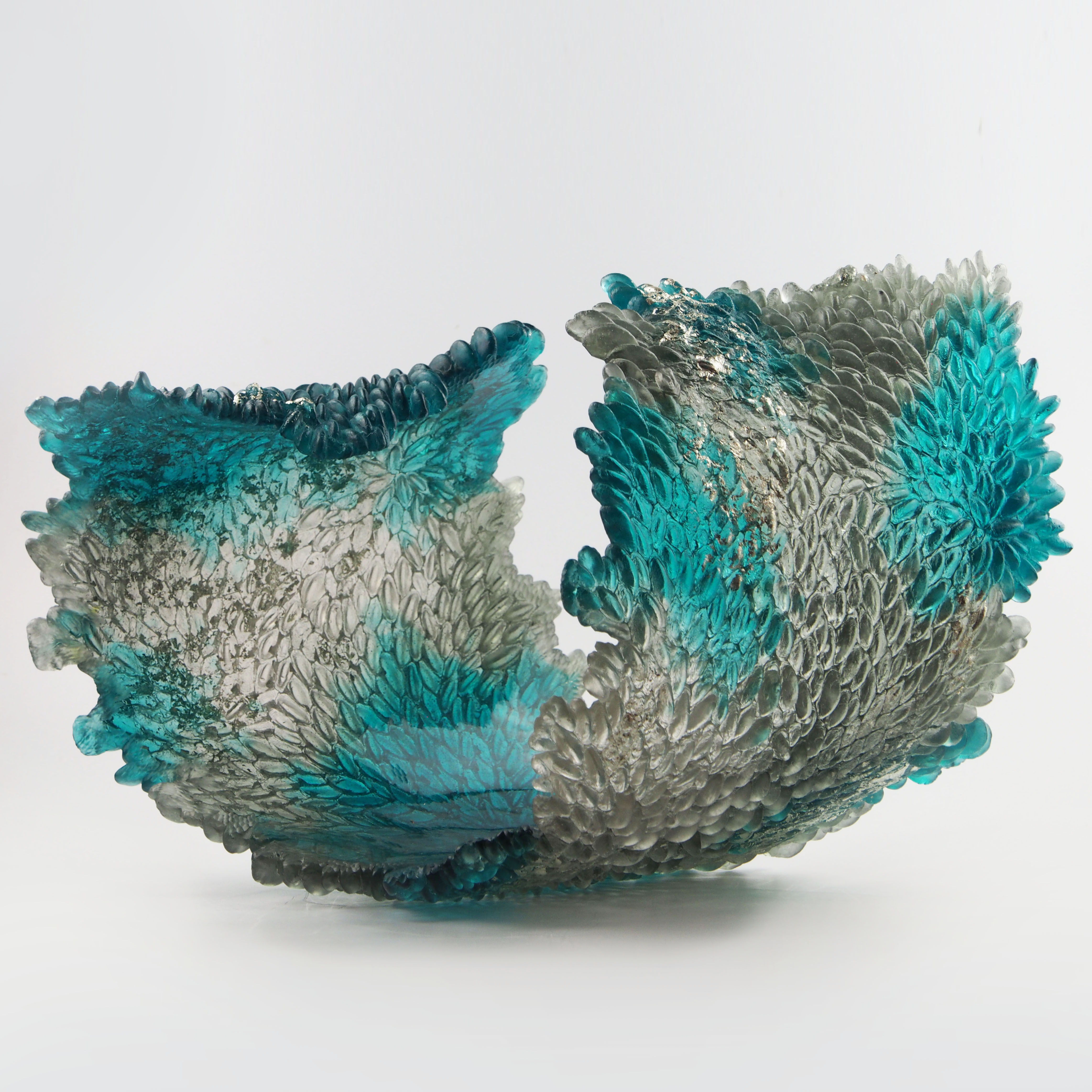 turquoise and clear art glass concave sculpture of wave shape