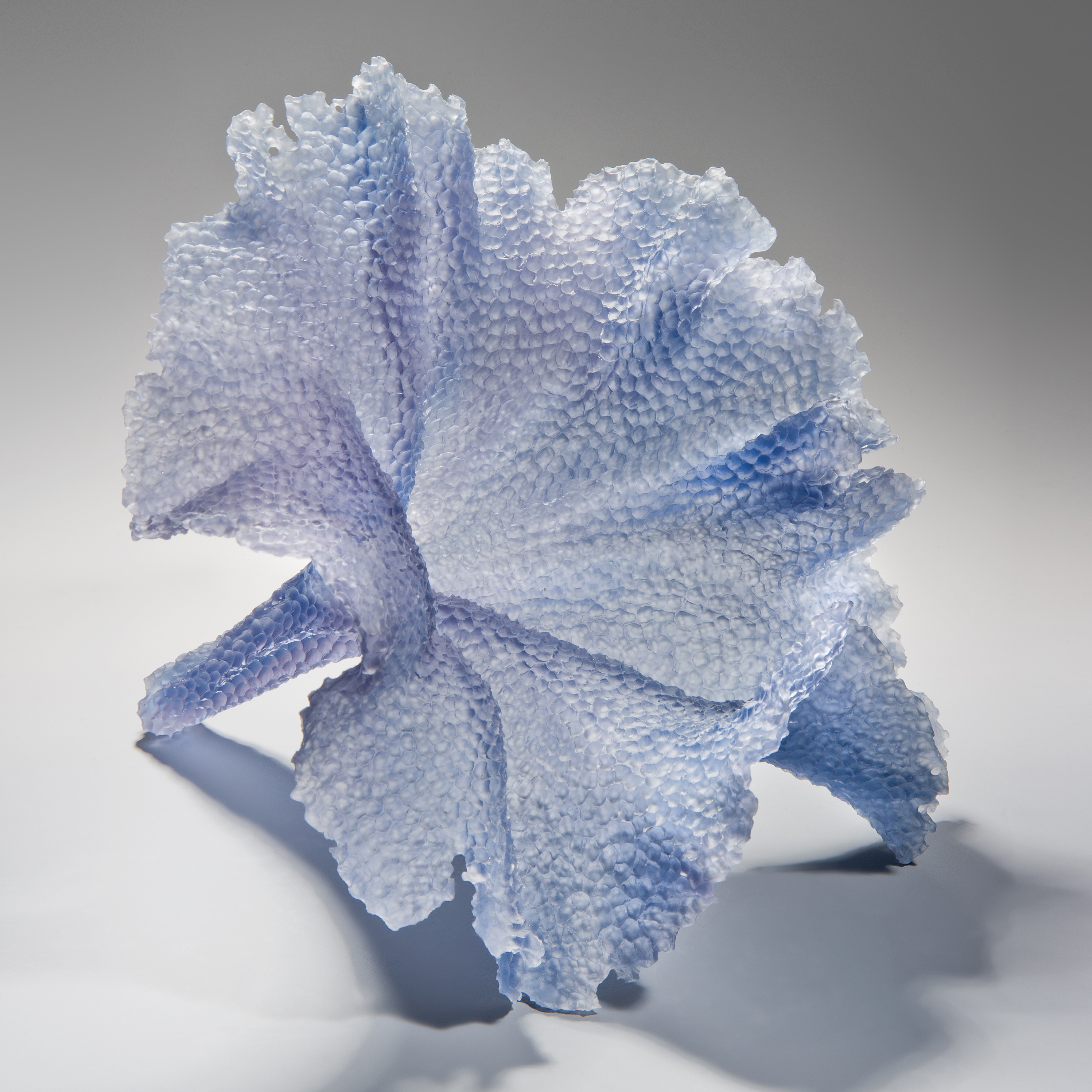 modern art glass sculpture of leaf in light blue