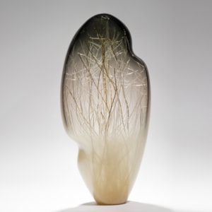 seethrough tall art glass sculpture with internal structure resembling abstract winter scene