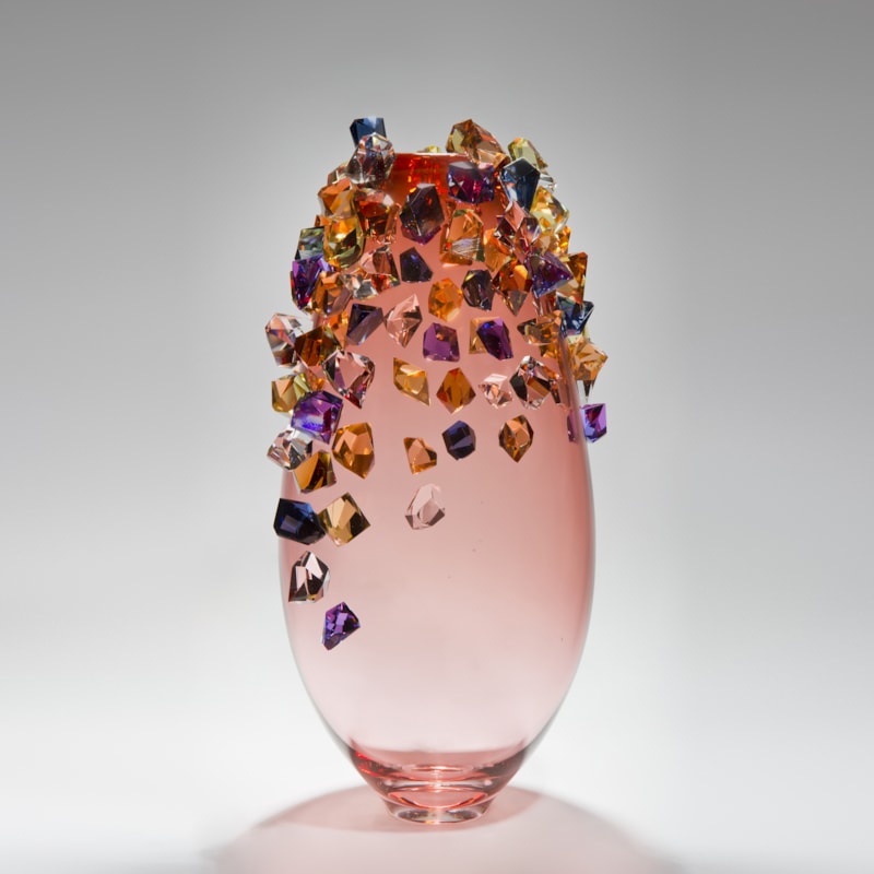 pink sculpted glass vase with colored crystals adorning the outer edges