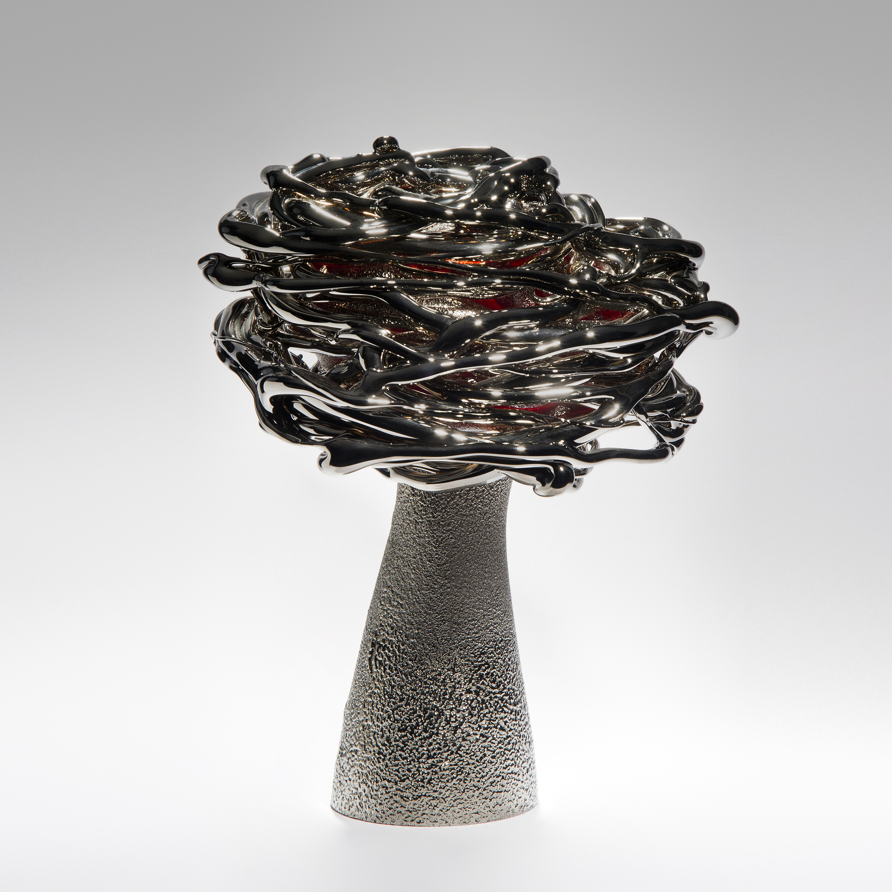 black red and platinum art-glass sculpture from blown glass of flower in wind