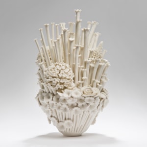 white porcelain sculpted artwork of roses sprouts and flowers