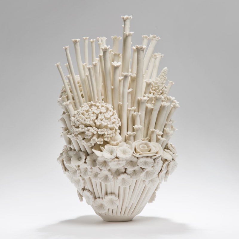 white porcelain sculpted artwork of roses sprouts and flowers