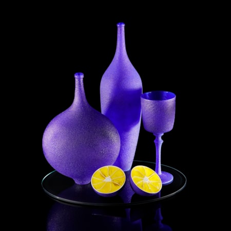 handblown and sculpted glass art still life in blue and yellow of lemons and ornaments