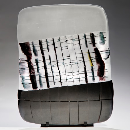 pictoral art glass sculpture in white grey and black on black metal stand