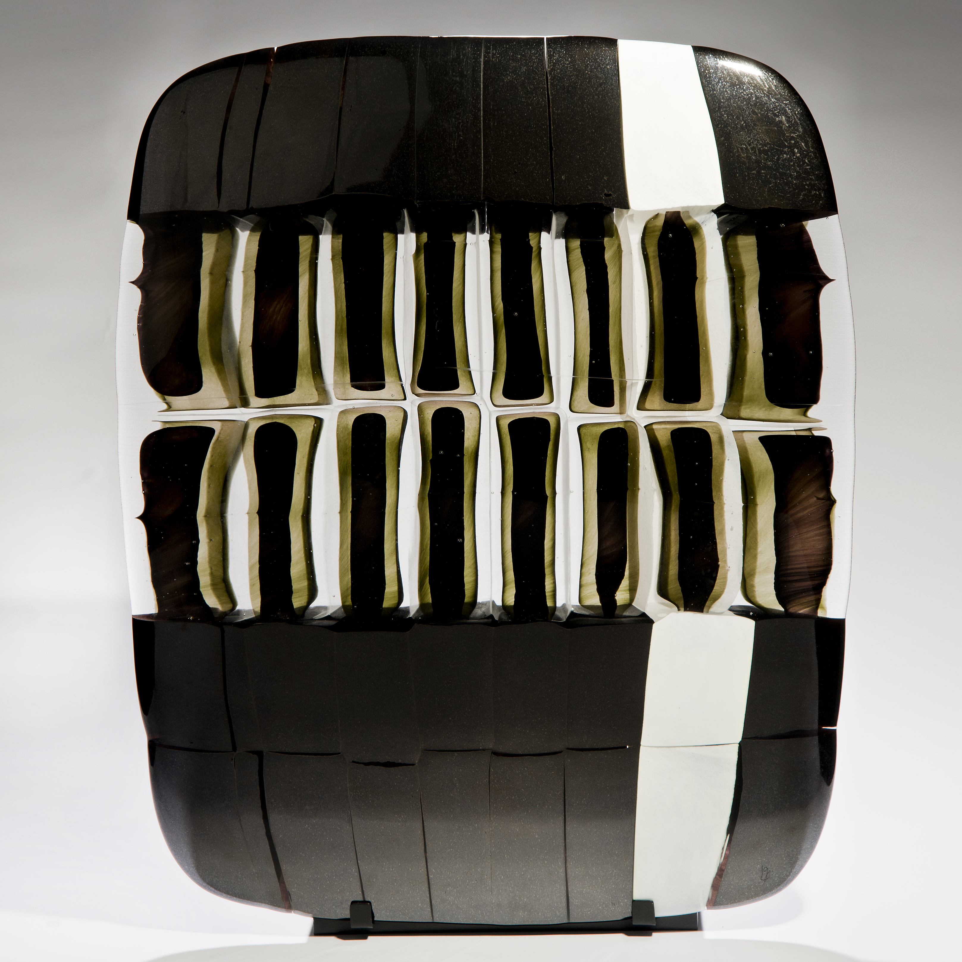 pictoral art glass sculpture in black and white on black metal stand