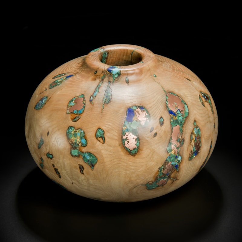 short sculpted vessel from natural looking ash wood and precious minerals in beige brown and speckled turquoise