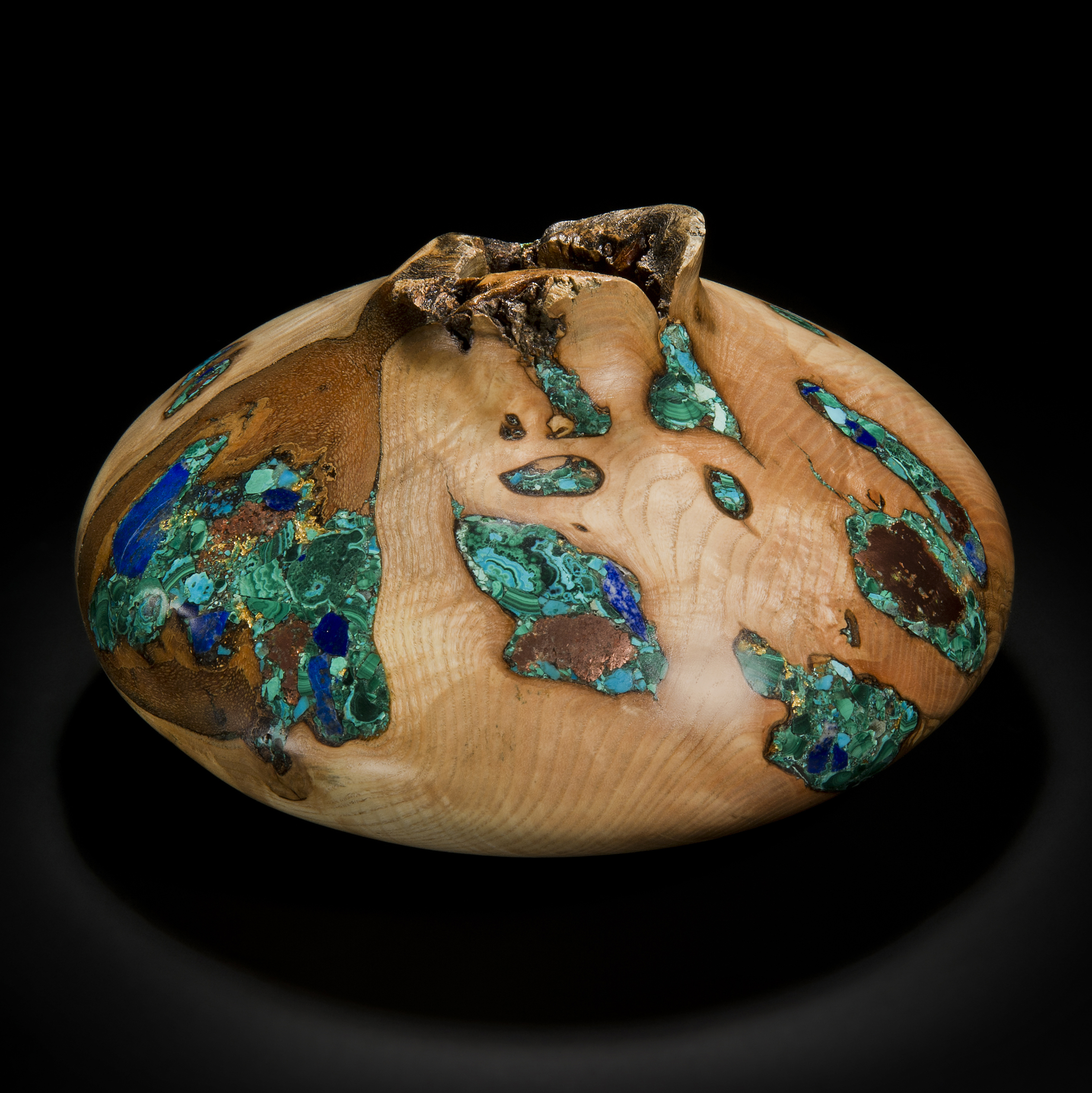 wide sculpted vessel made from ash inlaid with precious minerals in green and gold