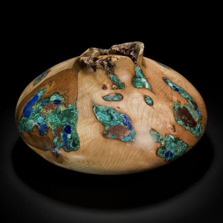 wide sculpted vessel made from ash inlaid with precious minerals in green and gold