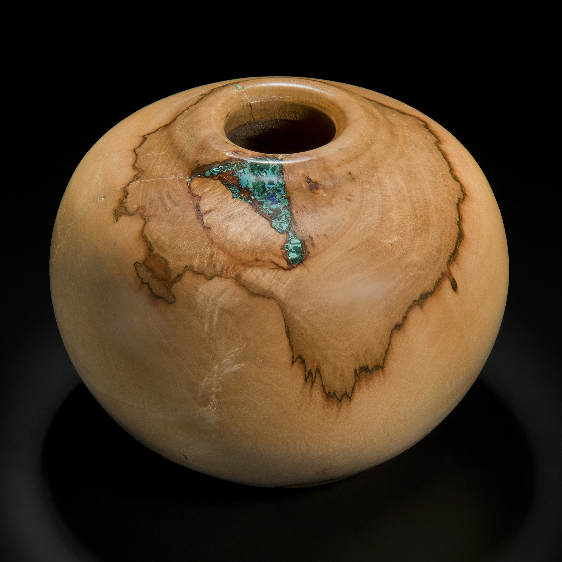 sculpture of vessel made from sycamore in creamy brown inlaid with precious minerals