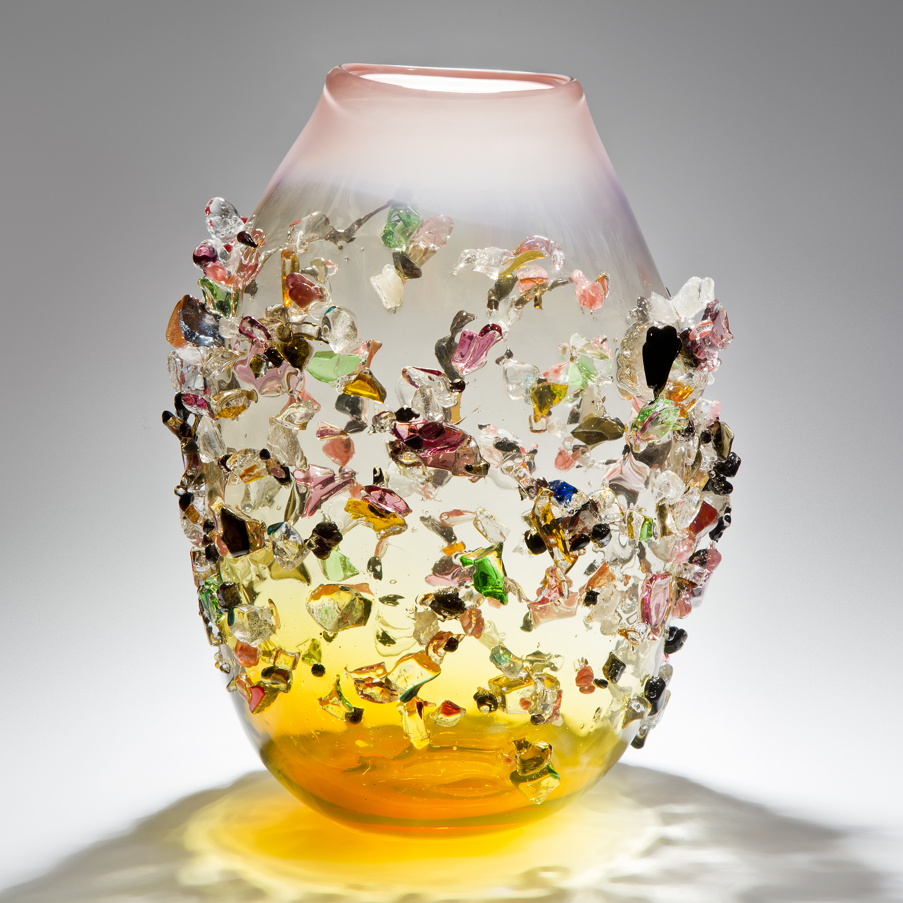 handblown glass vessel in amber and clear colours with multicoloured crystal adornments