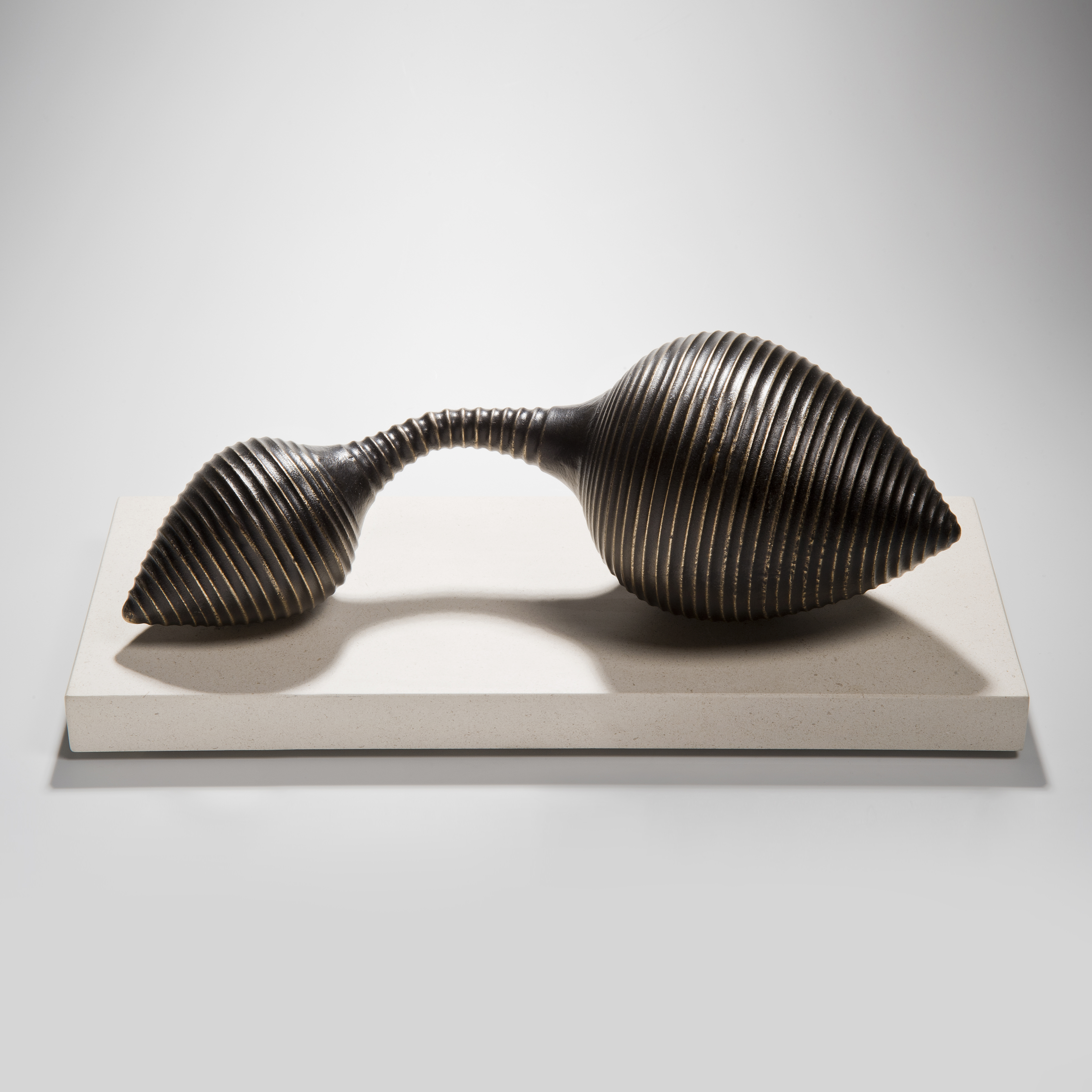 two ended conical terminal bronze sculpture on limestone base