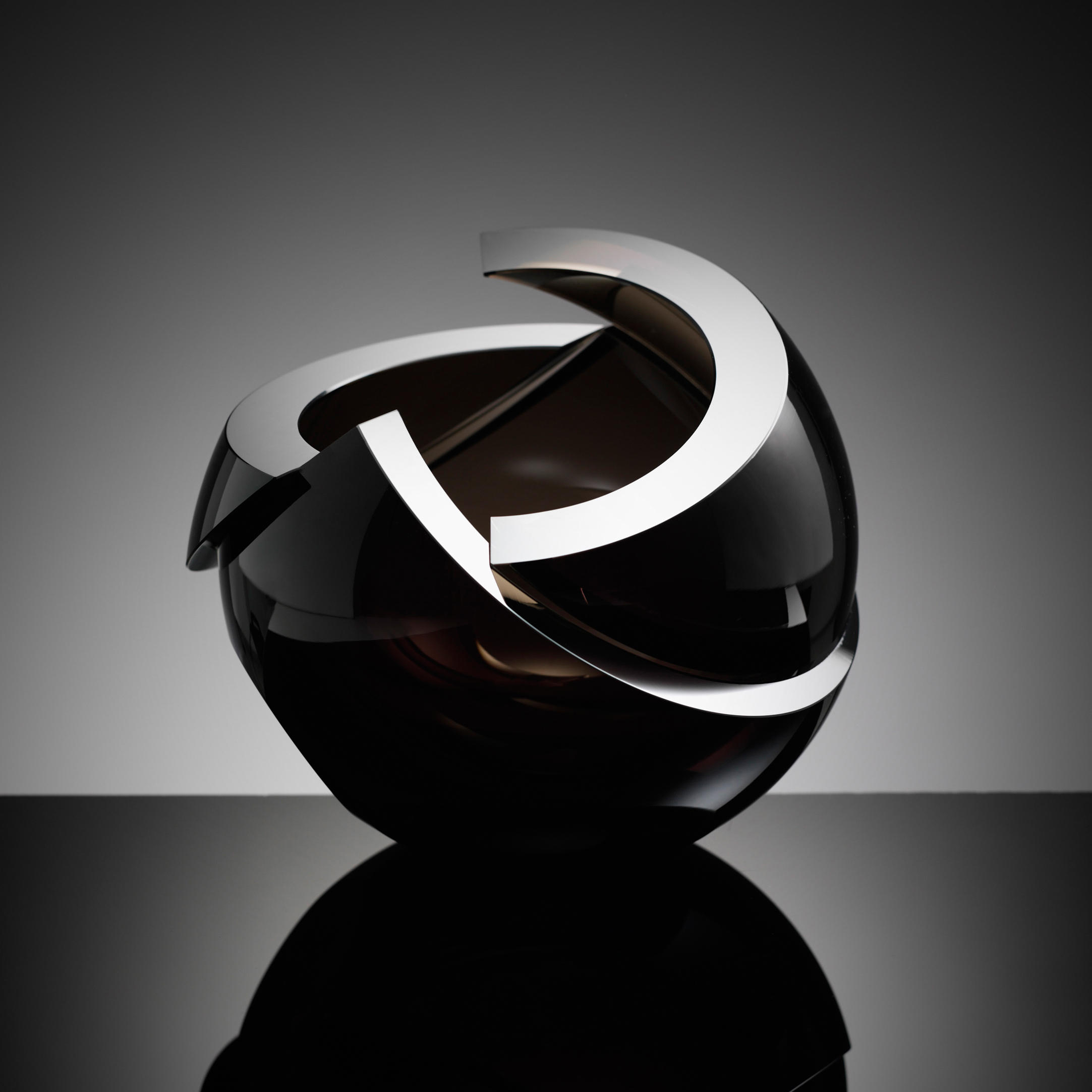 modern minimalist spherical art glass sculpture with sharp cuts in black
