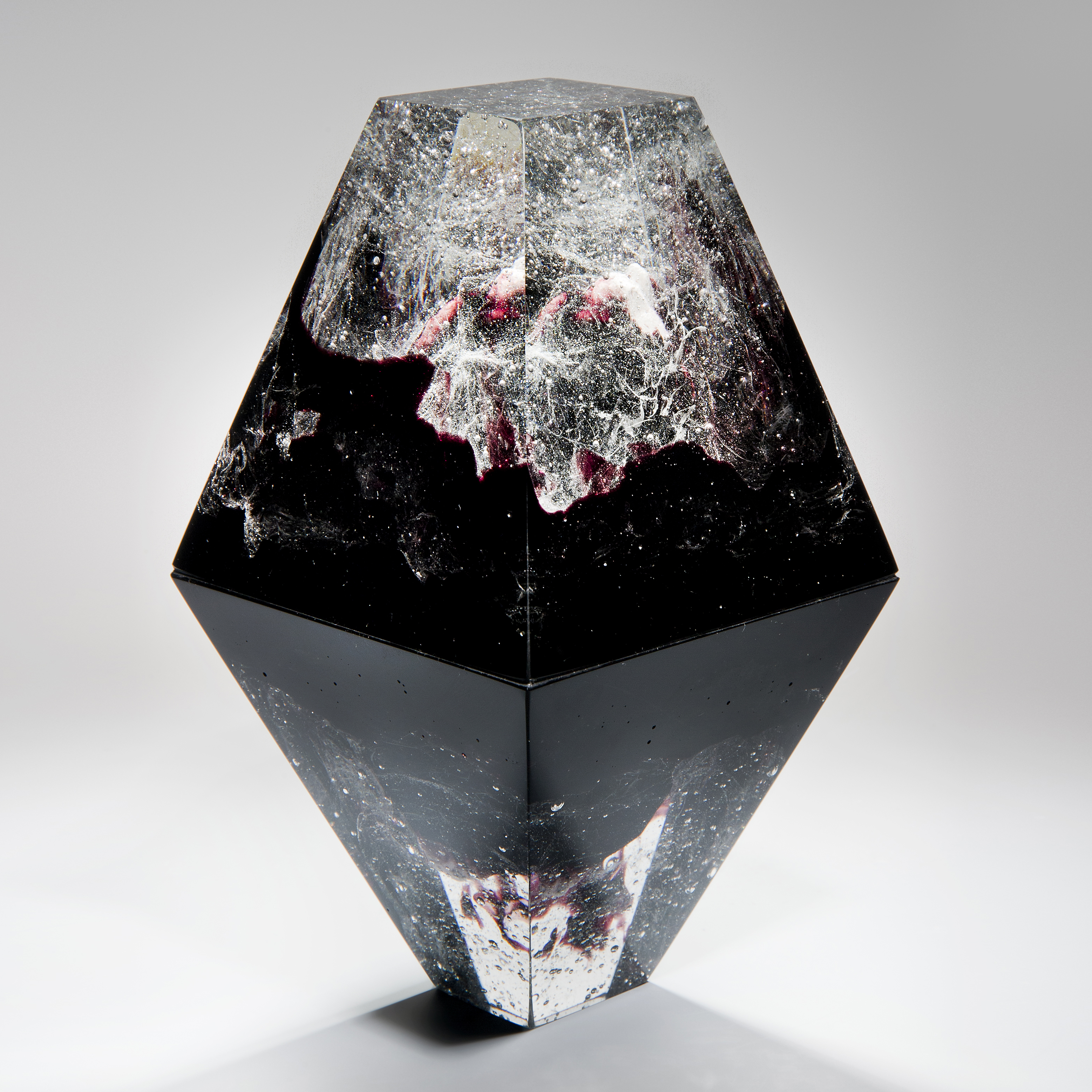 diamond shaped art-glass sculpture with plaster insert resembling frozen form in black crystal red 