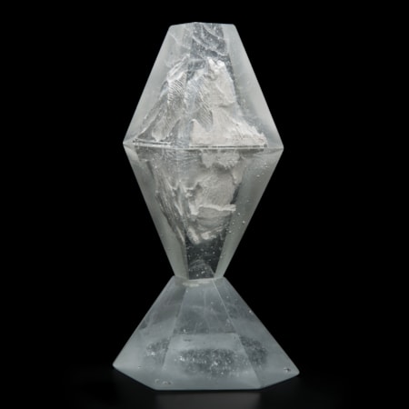 glass and plaster sculpture made to look like something trapped in diamond cut ice