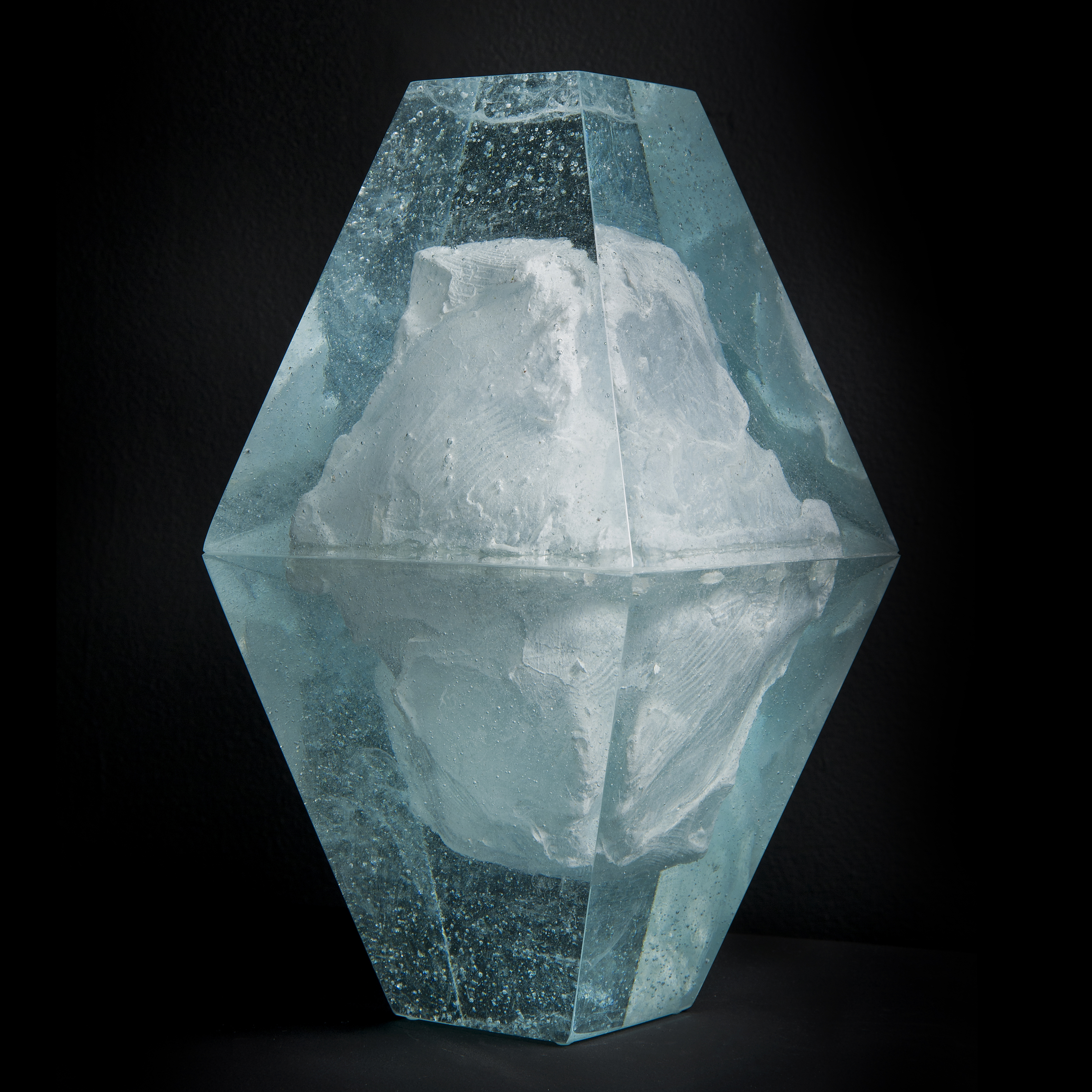 art glass sculpture of ice block frozen inside diamond shaped glass capsule