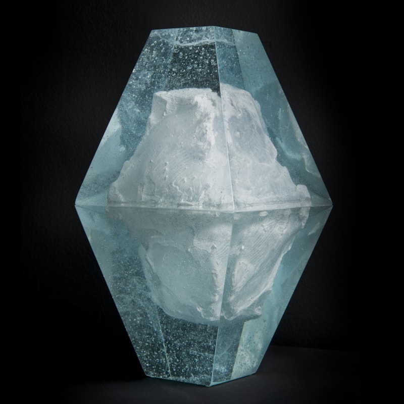 art glass sculpture of ice block frozen inside diamond shaped glass capsule