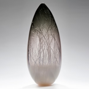 sculpted glass vessel in grey with wire interior resembling winter forest