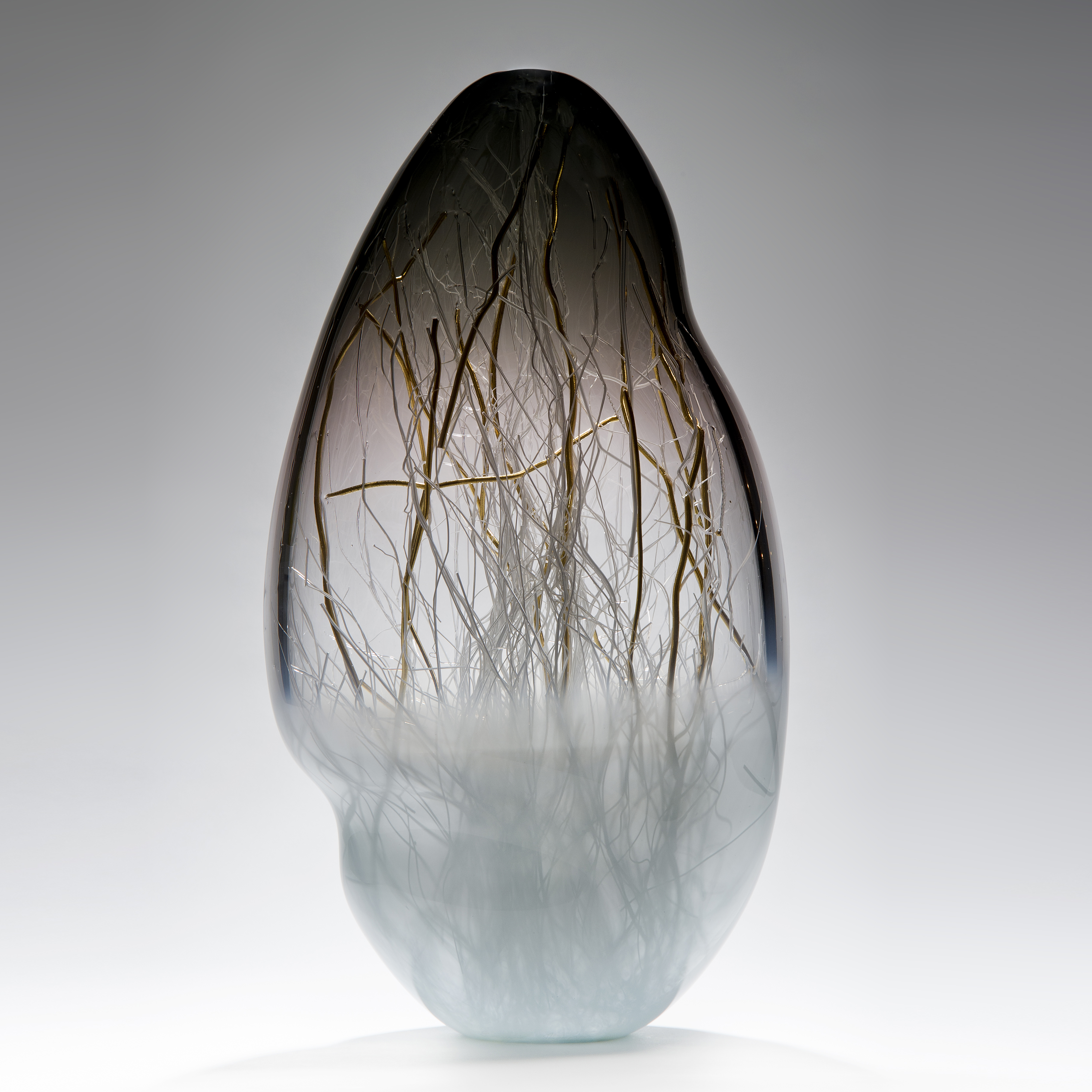 glass art vessel sculpture in grey and light blue with internal gold wire structure