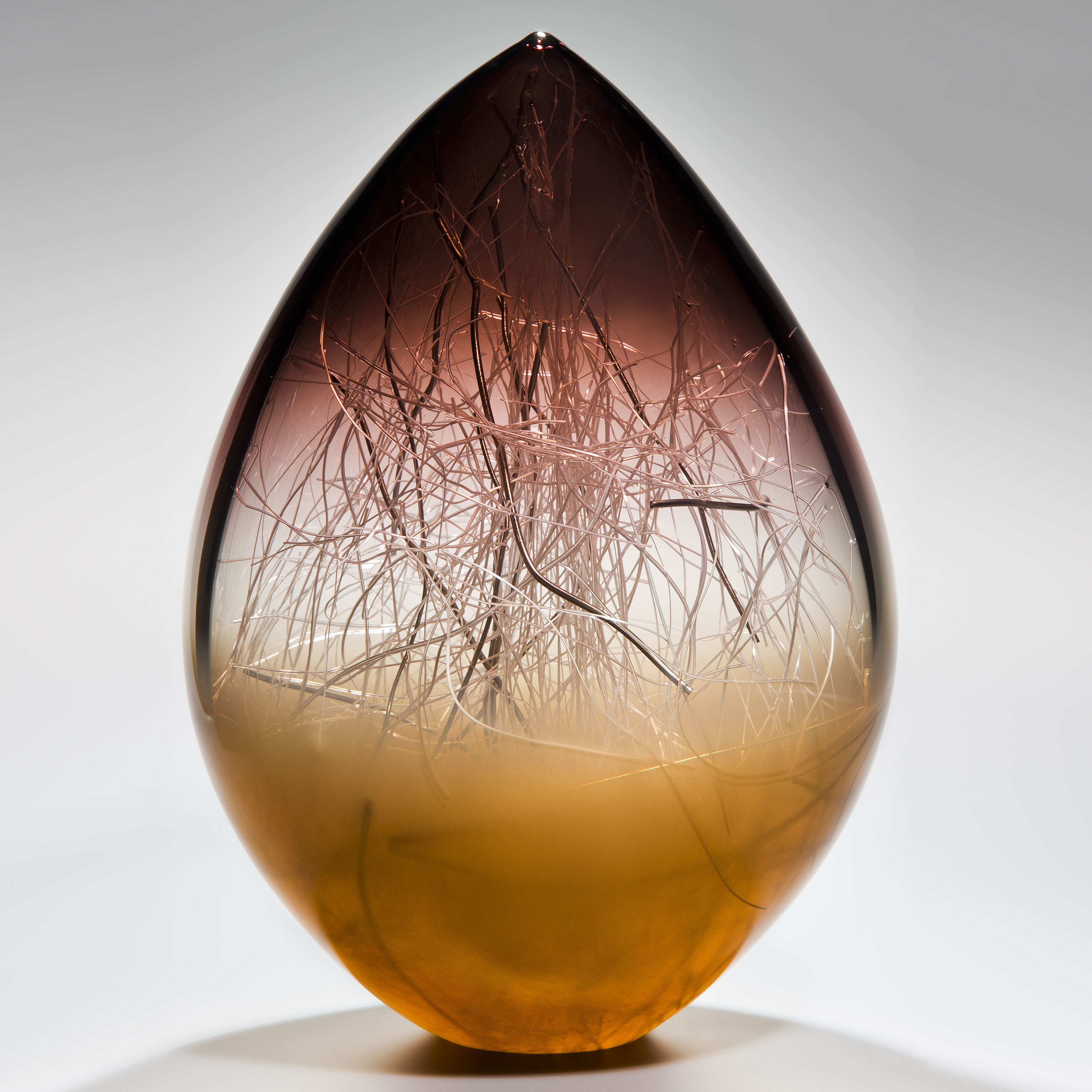 art glass sculpture in orb shape with aubergine and coffee colours and internal wire structure