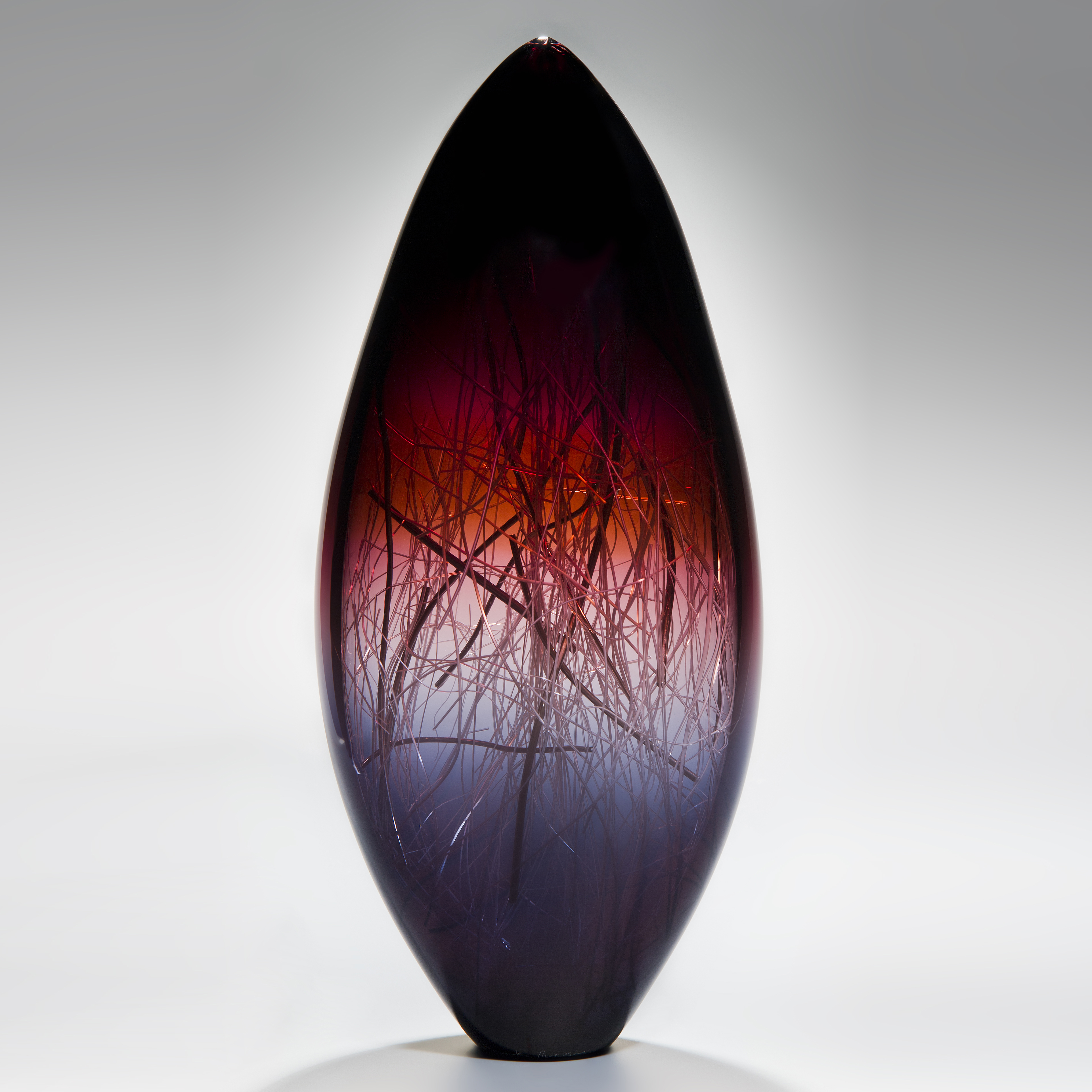 tall sculpted glass vase in deep violet red and black with internal wire structure