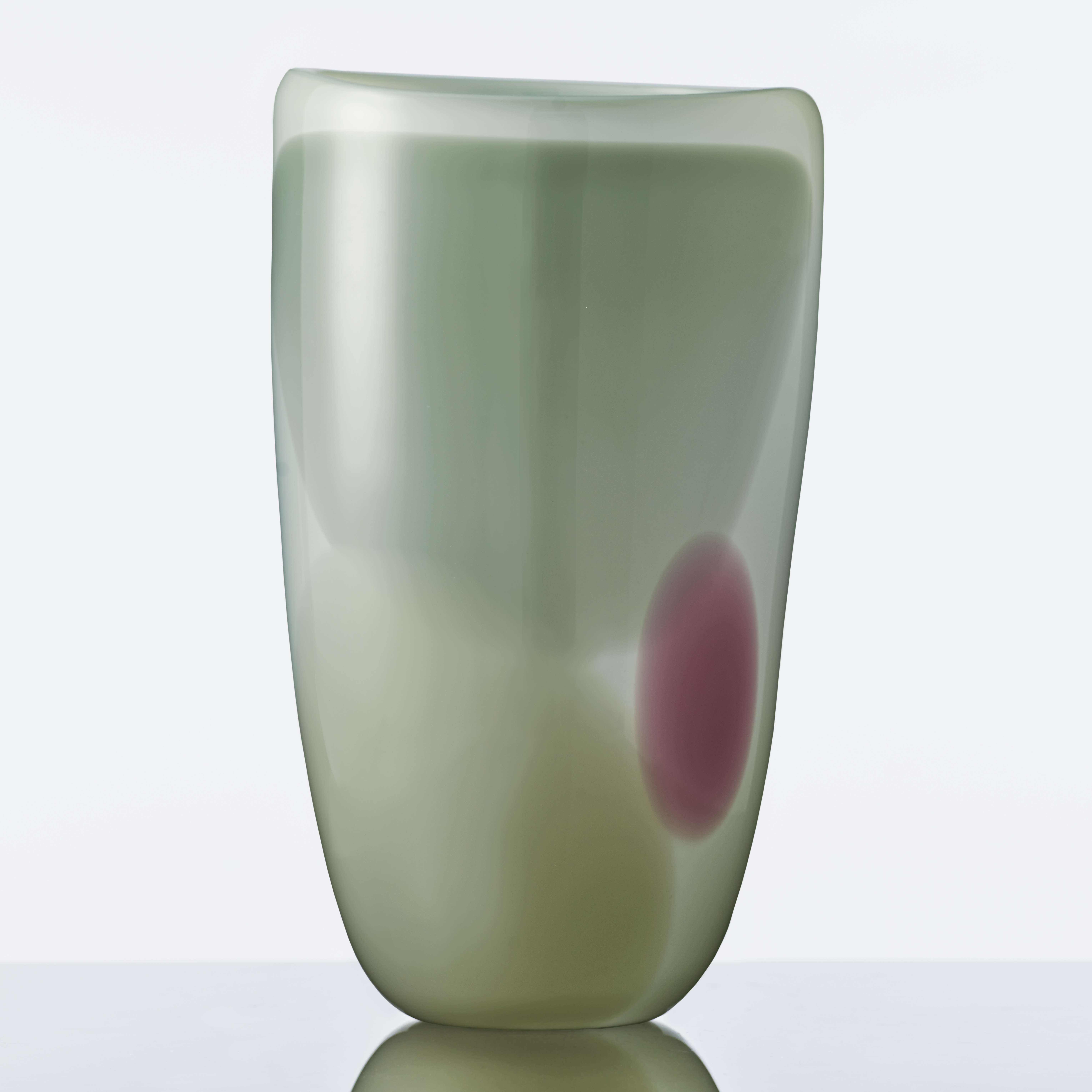 modern glassware vessel sculpture in shades of green with small purple patch