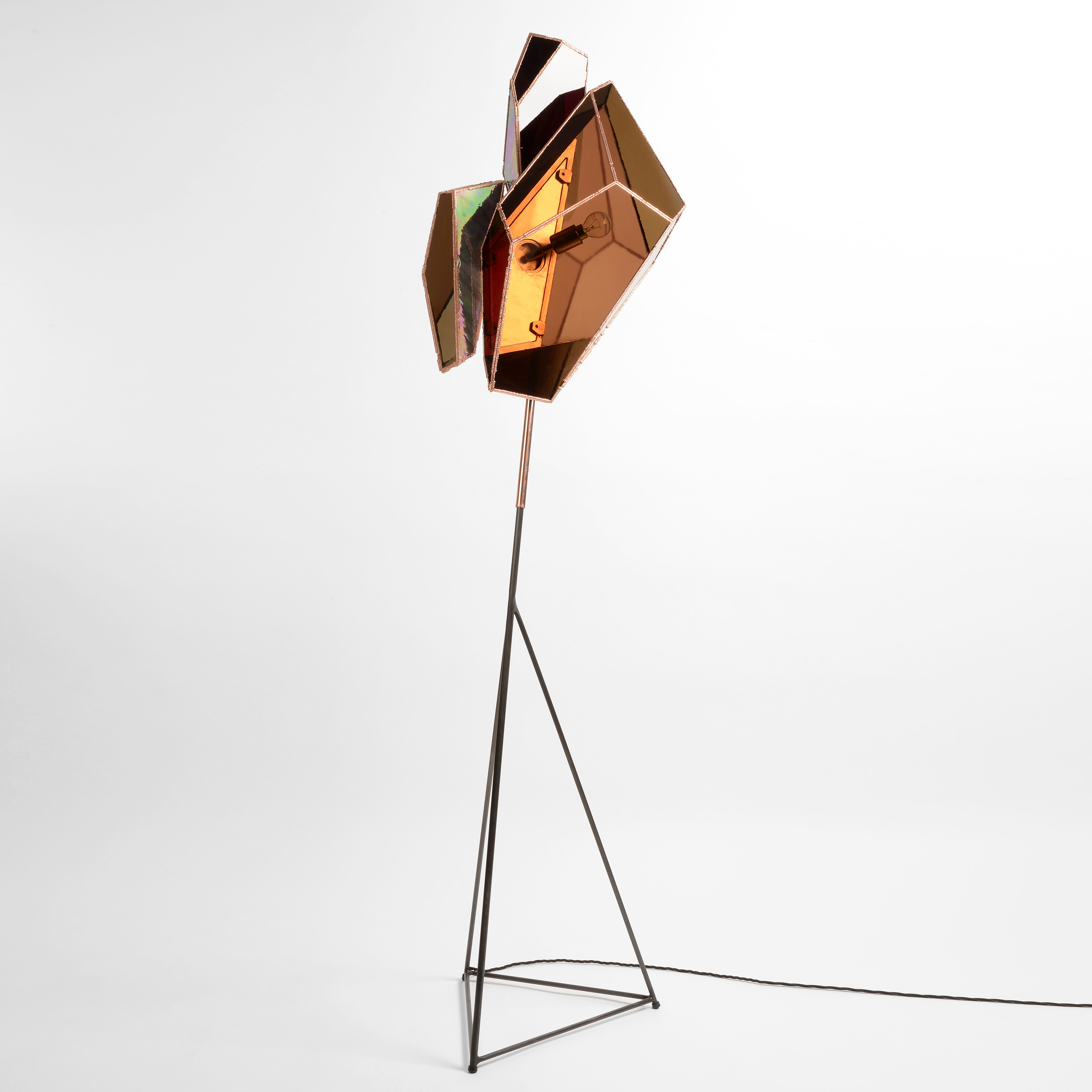 tall floor light with copper base and stained amber glass panels