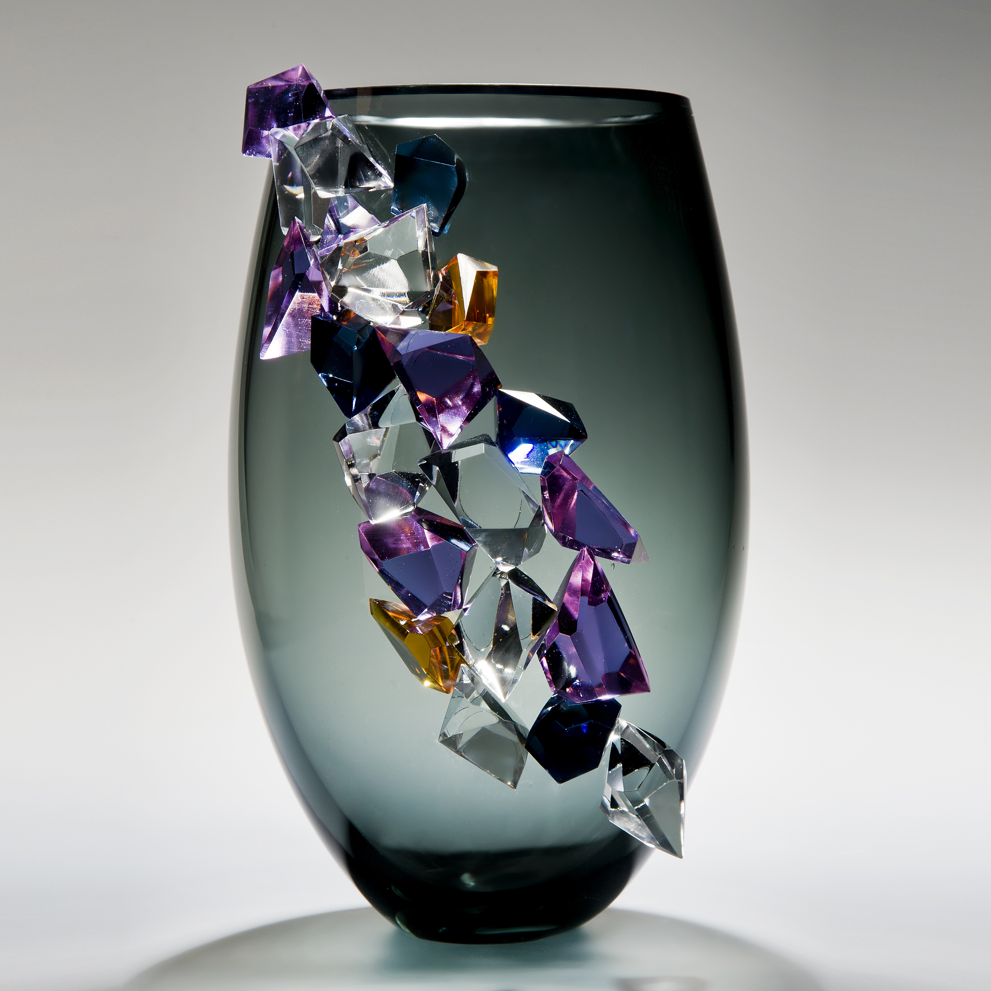 modern grey glass vase sculpture with large coloured crystal exterior