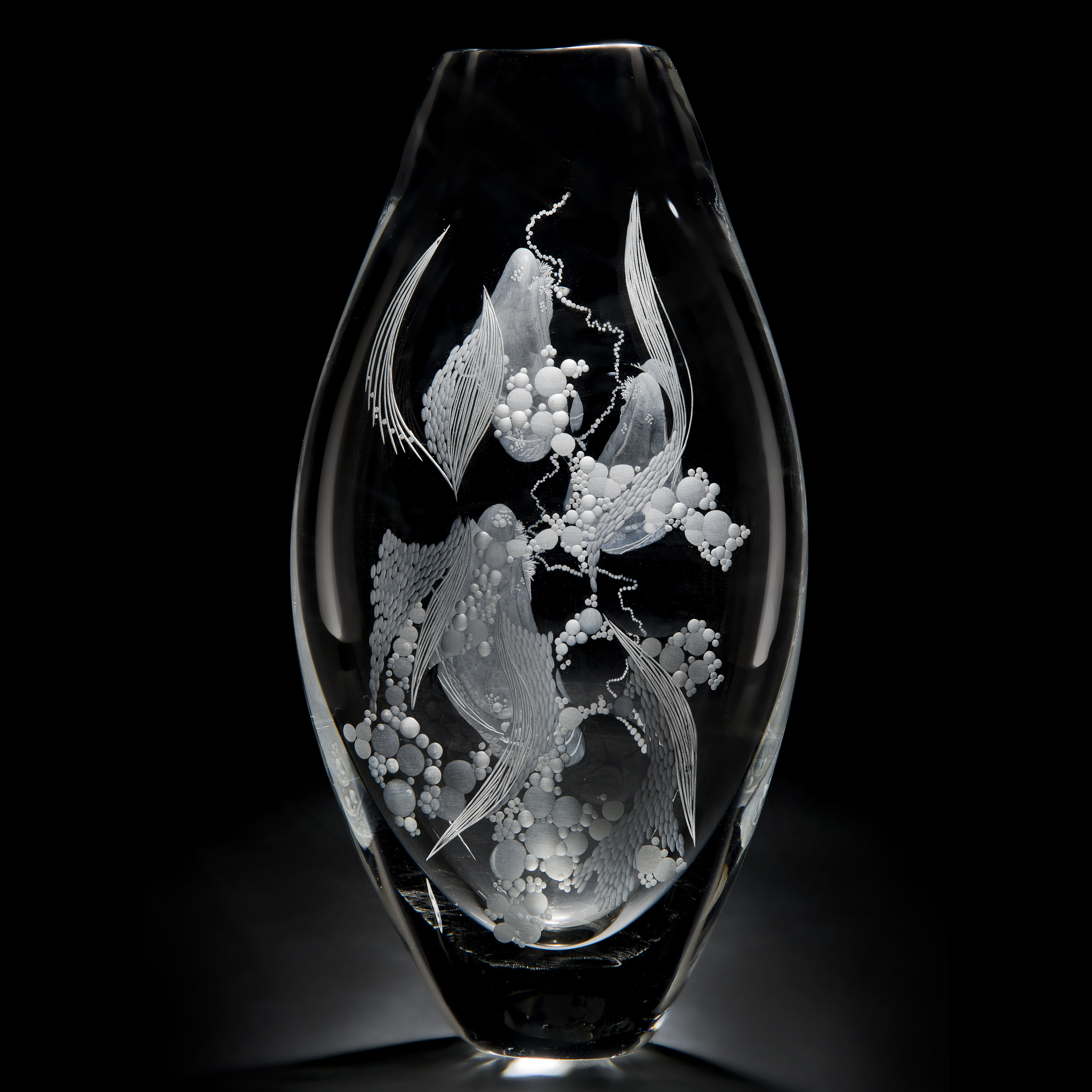 two clear glass vases with engraved flower patterns