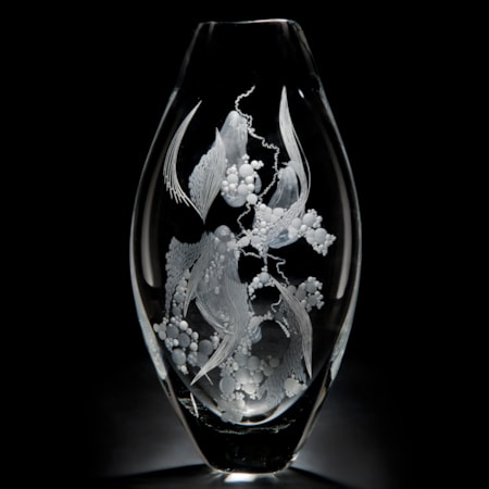 two clear glass vases with engraved flower patterns