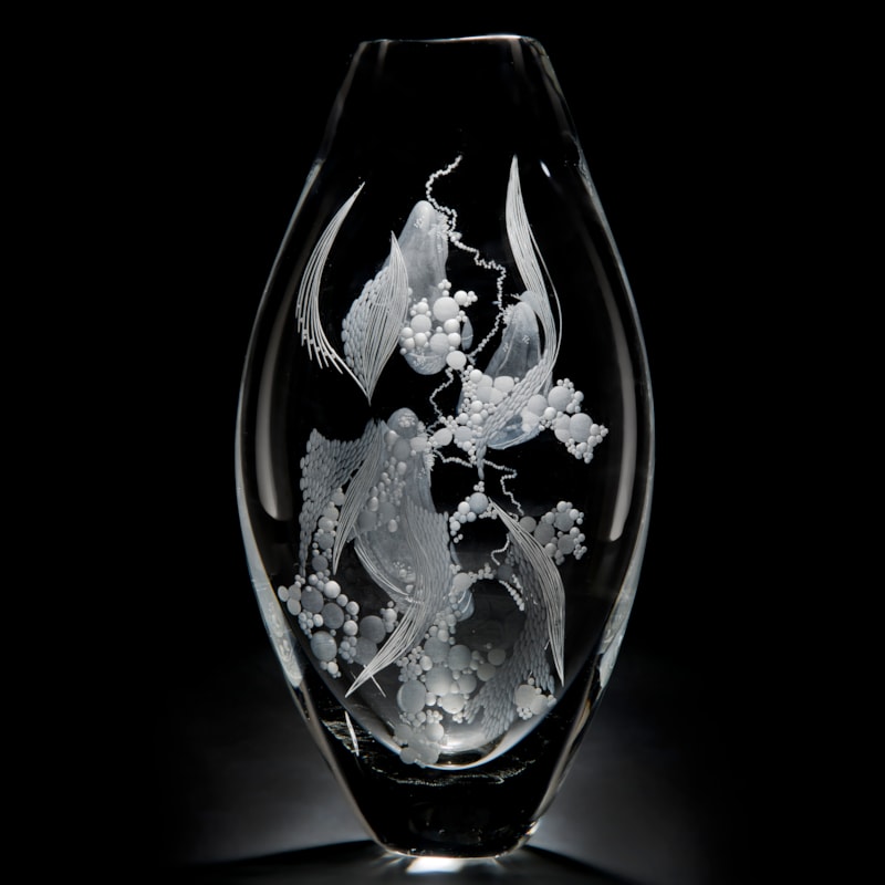 two clear glass vases with engraved flower patterns