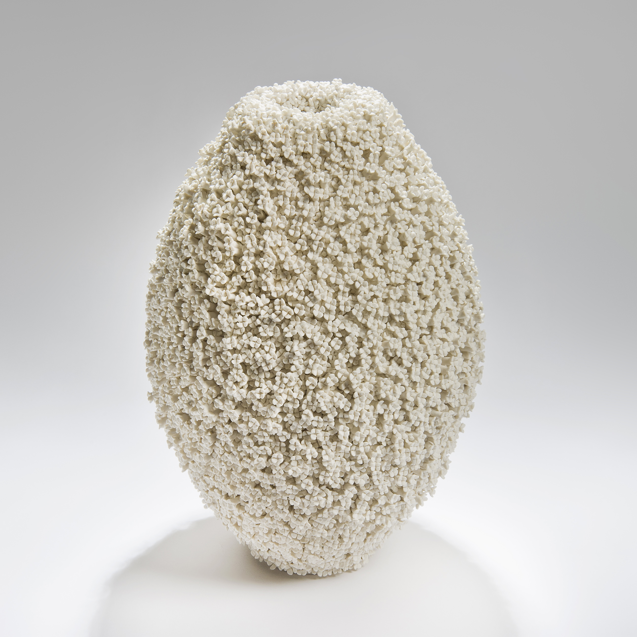 oval shaped ceramic sculptural vase with daphne floral pattern in cream