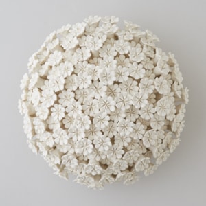 white porcelain sculpture of daisies arranged in sphere
