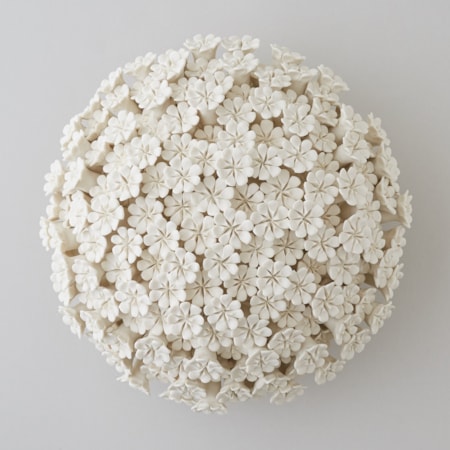 white porcelain sculpture of daisies arranged in sphere