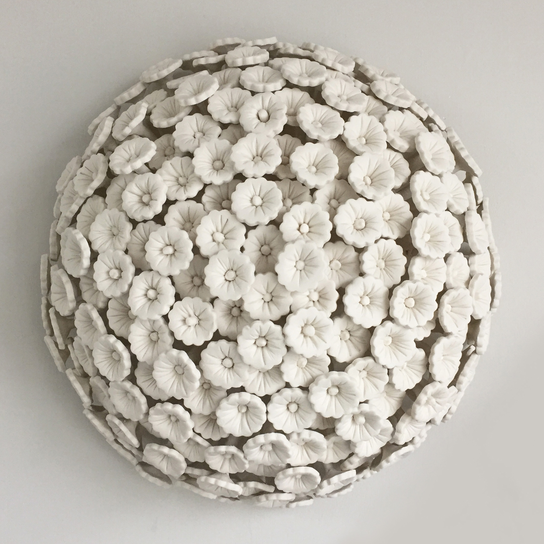 porcelain art sculpture of daisies arranged in sphere