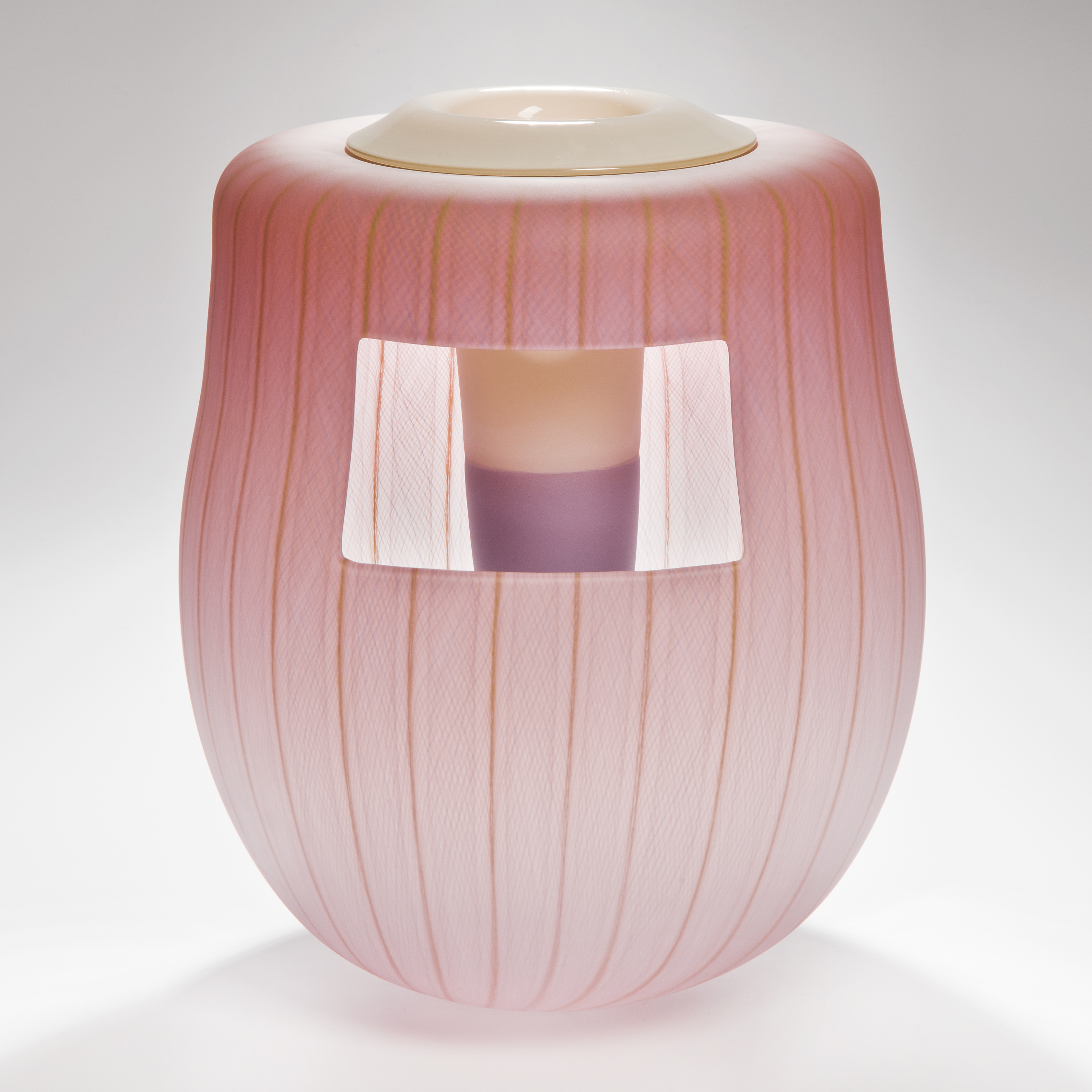 soft peach coloured glass art vessel sculpture with white window-like motif
