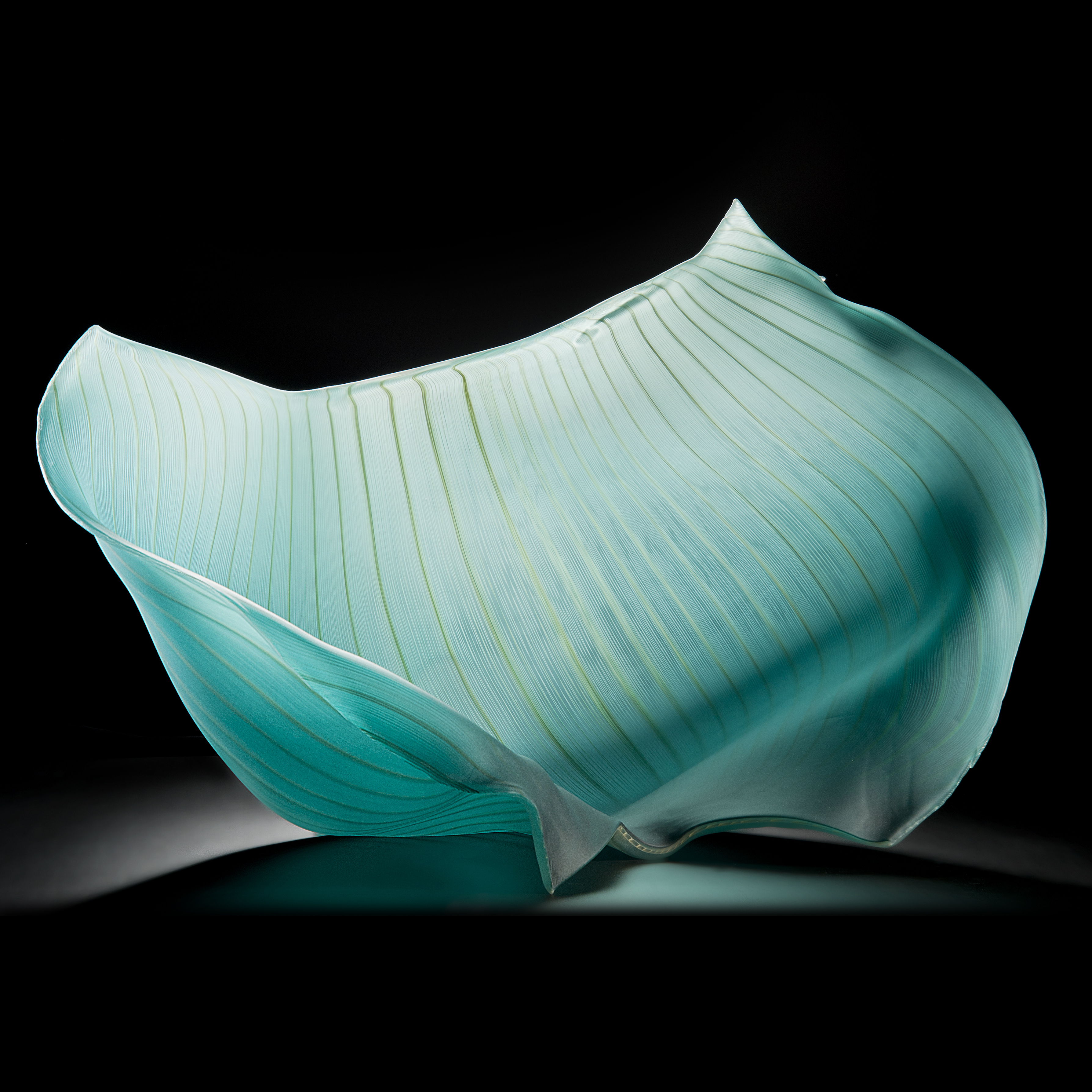 turquoise freehand blown glass sculpture of a petal