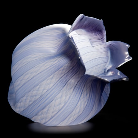 purple and lilac glass sculpture of open fruit with lined pattern