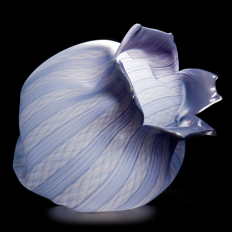 purple and lilac glass sculpture of open fruit with lined pattern